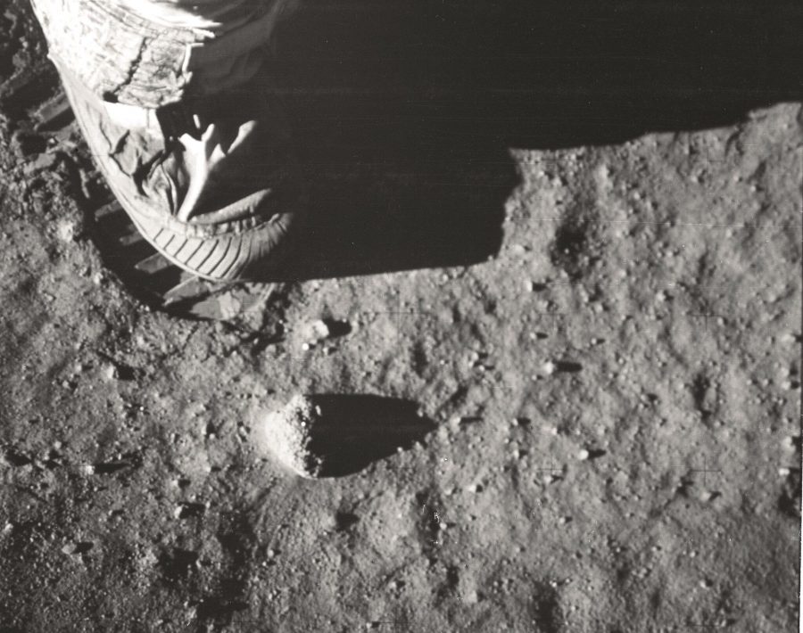 Un gros plan de la surface lunaire révèle des cailloux, de la poussière et la botte de Buzz Aldrin.